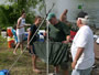 Tournament Director Jason Bernhardt (green shirt) weighs one of John Virginia's catches during the ASA tournament.