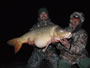 Paul Dinea (left) and Ioan Iacob pose with Lake Fork's record-setting common carp that was named Woody (35.0 lbs). Lake Fork, TX