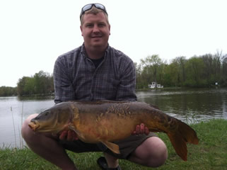 Scott Titus with a 20.5 lb mirror carp caught during 