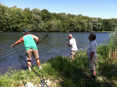 Don Knowles (left) assists Joe Rinaldo III (center) while Scott Johnson (right) looks on