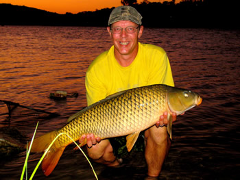 Wild Carp Club of Austin Director Keith Thompson enjoys a beautiful sunset with a common carp.